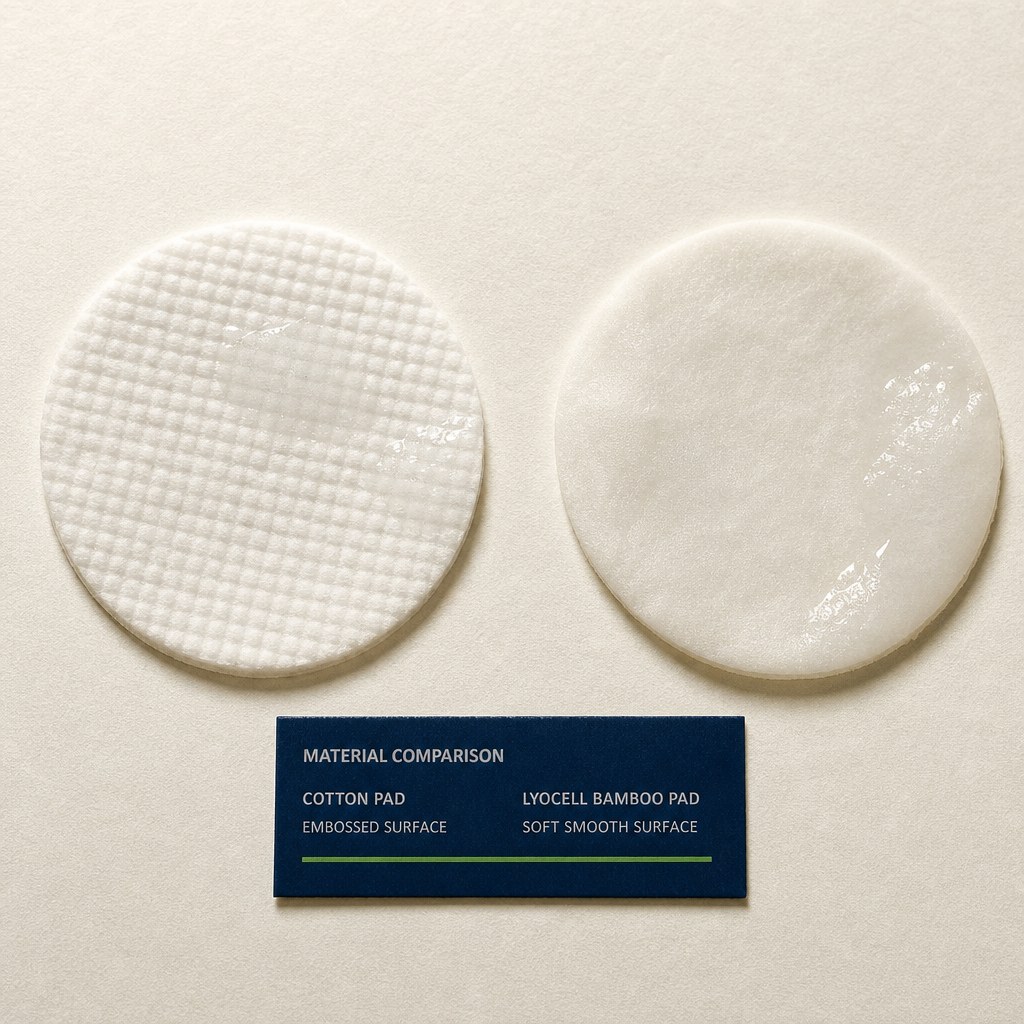 Macro detail of an embossed cotton treatment pad and a lyocell bamboo barrier pad on warm paper